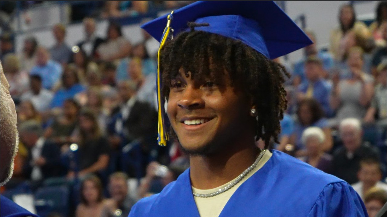An RHS student smiles with satisfaction during the 2023 graduation ceremony.